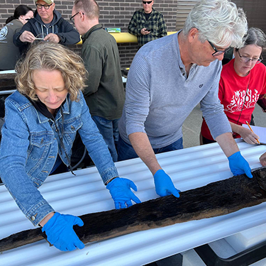 Jim and Kat Laptham examine the canoe.